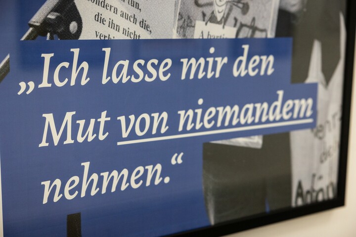 Nahaufnahme einer Informationstafel mit der Aufschrift "Ich lasse mir den Mut von niemandem nehmen."
