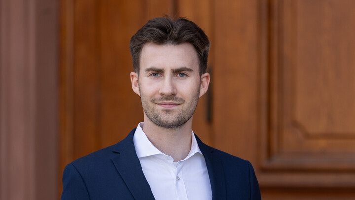 Daniel Weiß wearing a suit.