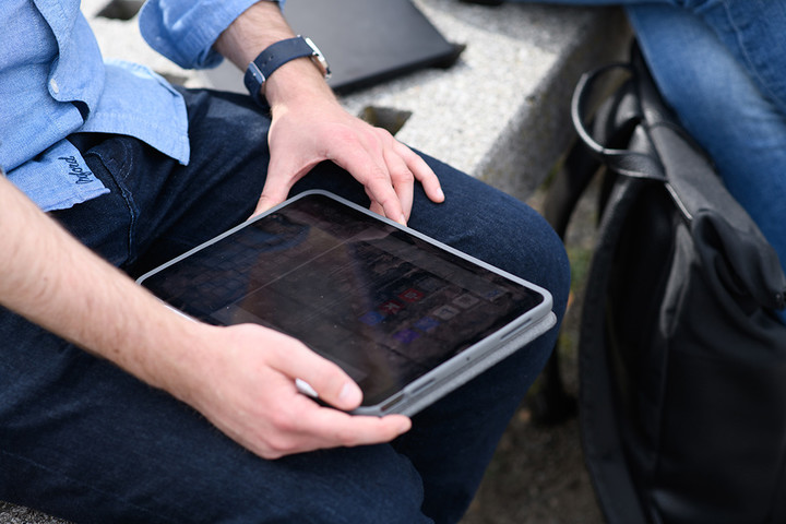 A man is holding a tablet.