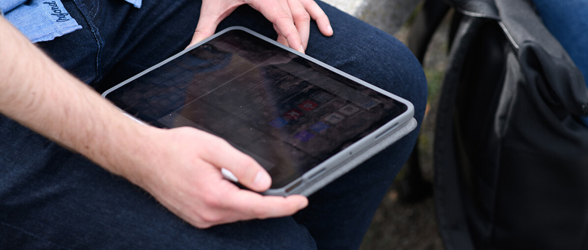 A man is holding a tablet.