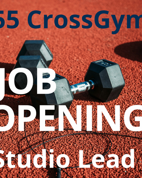 Zwei schwarze Kurzhanteln und ein Springseil liegen auf einem roten Gummiboden, wie er typischerweise in Sportanlagen zu finden ist. Darüber ist groß in weißer Schrift zu lesen: „JOB OPENING – Studio Lead”. Oben steht in blauer Schrift „55 CrossGym”.