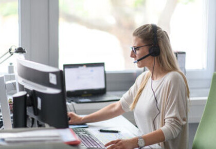 Person with headset sitting at computer