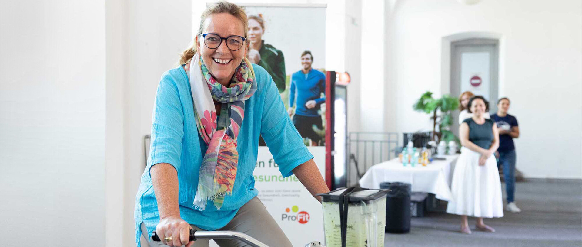 Mitarbeitende sitzt auf einem Smoothie Bike