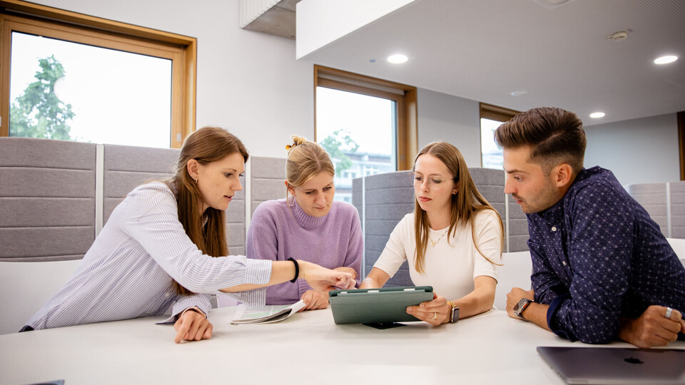 Group of four researchers in the university’s building in B6