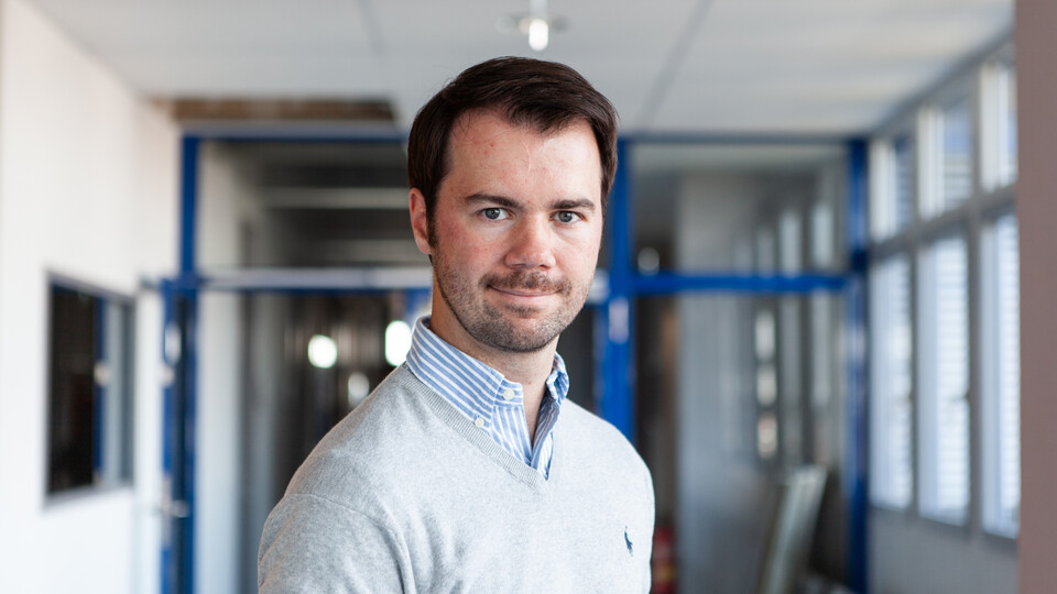 Marc Philipp Janson wearing a white shirt in front of a glass door.