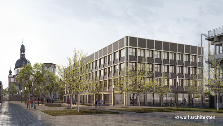 Visualisierung des neuen UNIT-Gebäudes. Vor dem rechteckigen Neubau stehen Bäume auf Grünflächen.