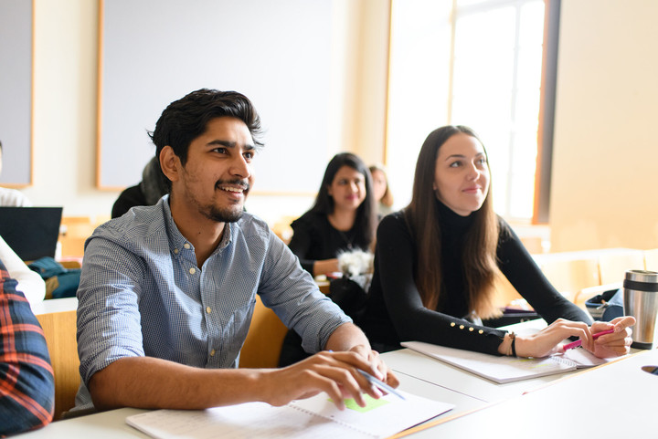 Students listen enthusiastically to a lecture.