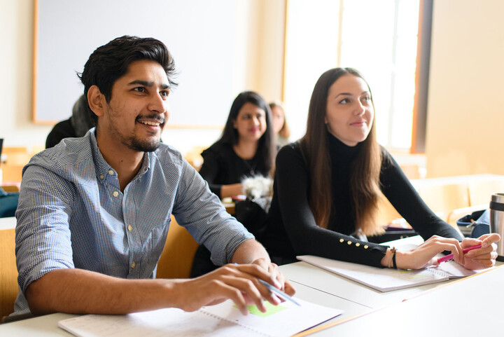 Students listen enthusiastically to a lecture.