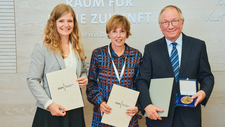 Die Preisträger*innen Dr. Jana Berkessel, Prof. Dr. Michaela Wänke und Prof. Dr. Edgar Erdfelder präsentieren ihre Urkunden.
