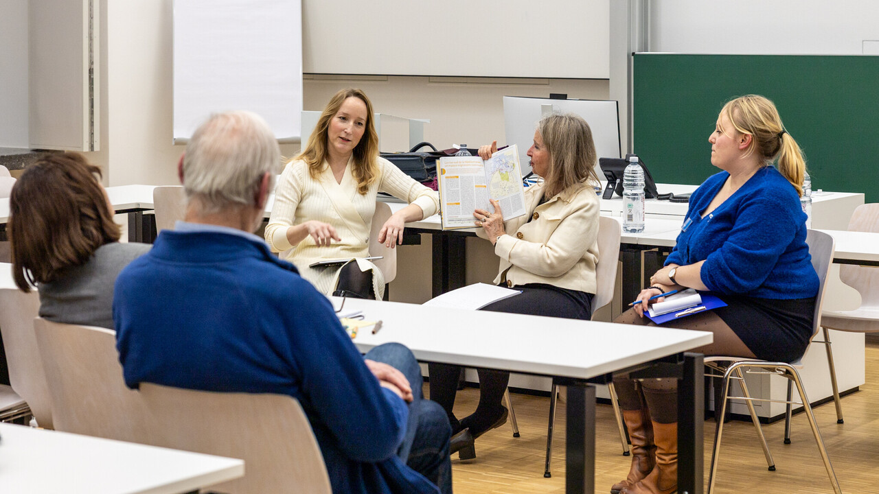 Gesprächsrunde bei einer Vernissage im Seminarraum.