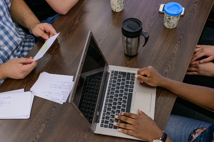 Students work at the table on a laptop