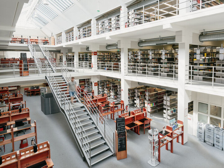 Bibliotheksbereich A3: Großzügige, helle Bibliothek mit Treppe in der Mitte