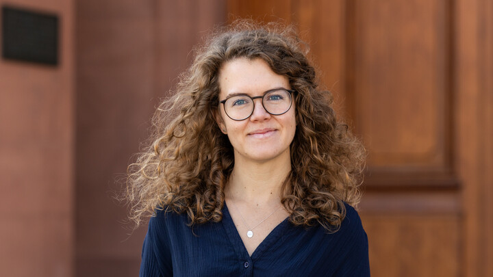 Friederike Lötters. She has long brown hair and is wearing a black blouse.