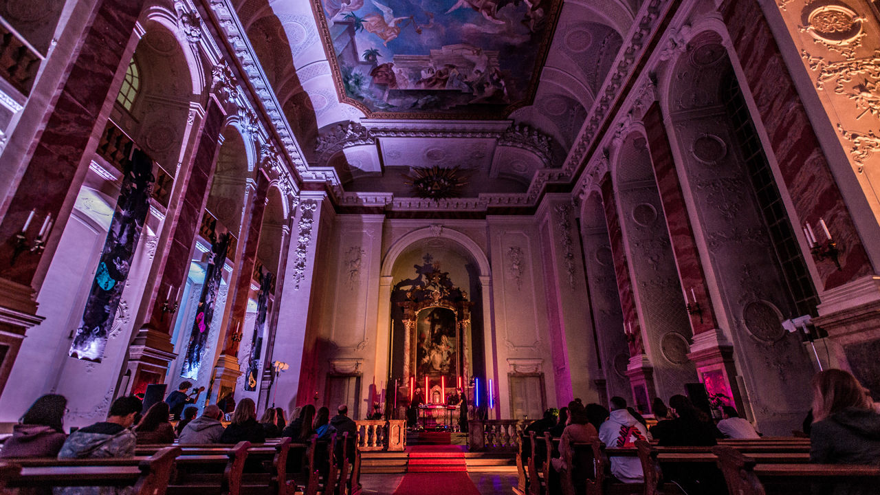Menschen hören Musikern in der Mannheimer Schlosskirche zu.