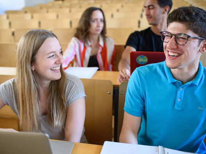 Four students in the lecture hall.