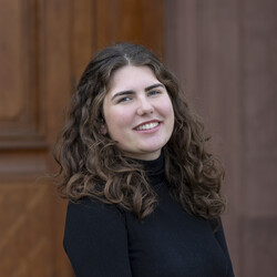 Marie von Lanken Schulz has brown curly hair. She is wearing a black turtleneck sweater.