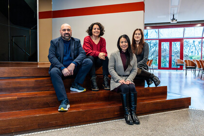 Vier Personen sitzen auf einer Treppe