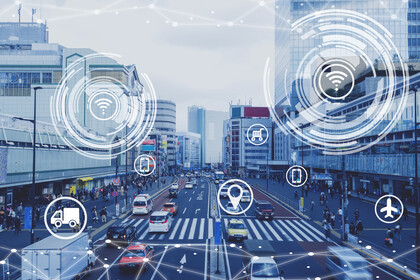 Straße in einer Großstadt mit Verkehr und Fußgängern, überlagert von Symbolen für Logistik, Standort, Smartphone, Flugzeug und Einkaufswagen.