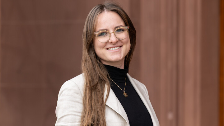 Julia Koziarowski wearing a black shirt and white blazer.