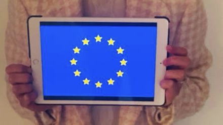 On a tablet screen the flag of Europe can be seen.