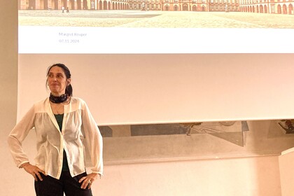 Margret Keuper steht vor der Leinwand während Ihres Vortrags.