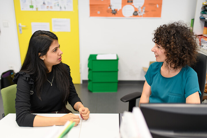 A staff member and a student in a meeting.