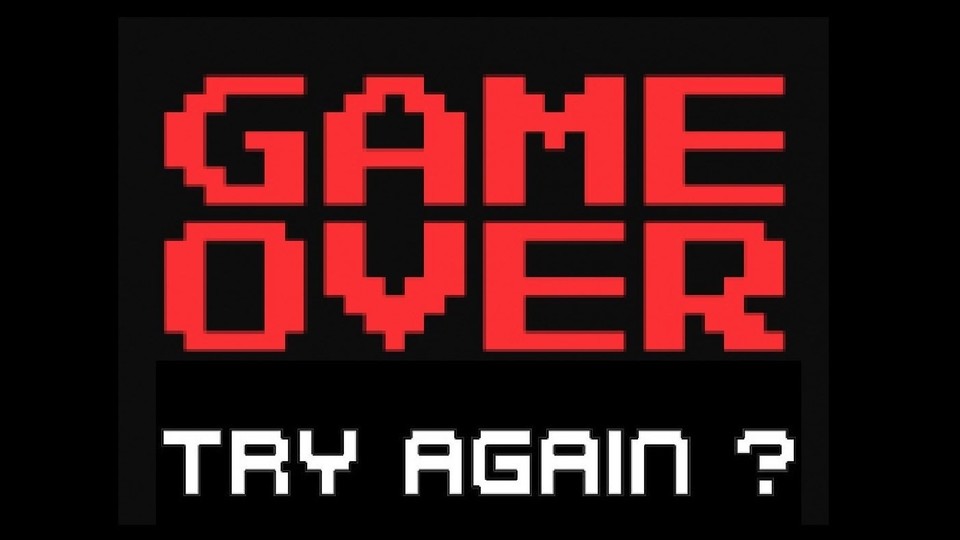 Der rot-weiße aus Computerspielen bekannte Schriftzug "Game Over - Try again?" leuchtet auf schwarzem Hintergrund.