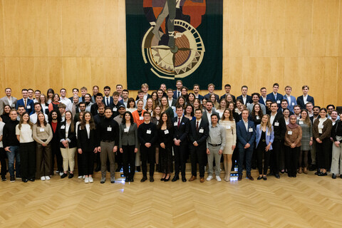 Fast 100 Studierende stehen zusammen und posieren für ein Foto.