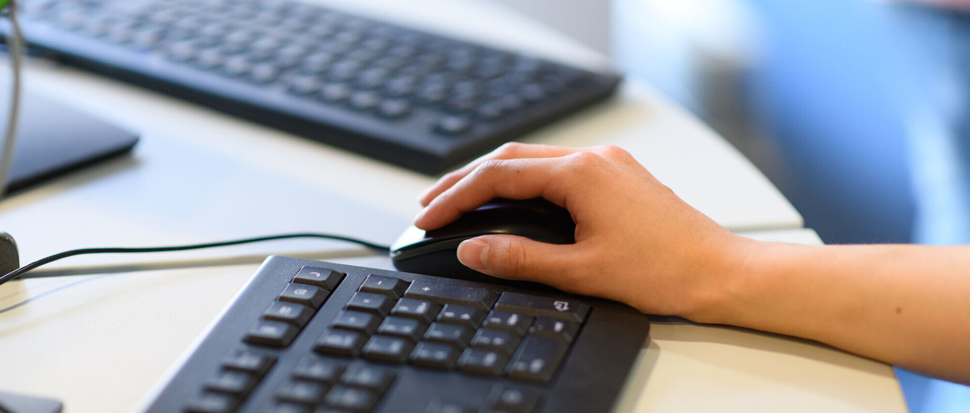 Hands of a person working on a laptop
