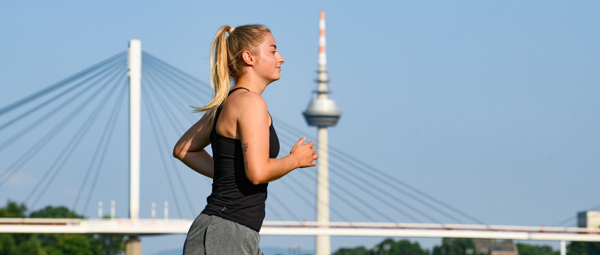 student in sports equipment running in an urban area