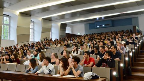 Studierende sitzen in einem vollen Hörsaal.