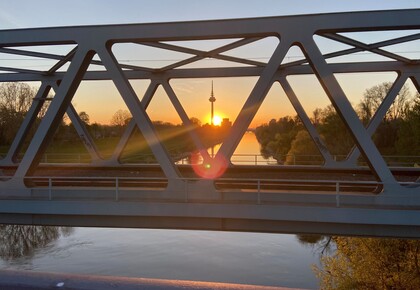 Riedbahnbrücke im Abendlicht. Im Hintergrund der Fernmeldeturm