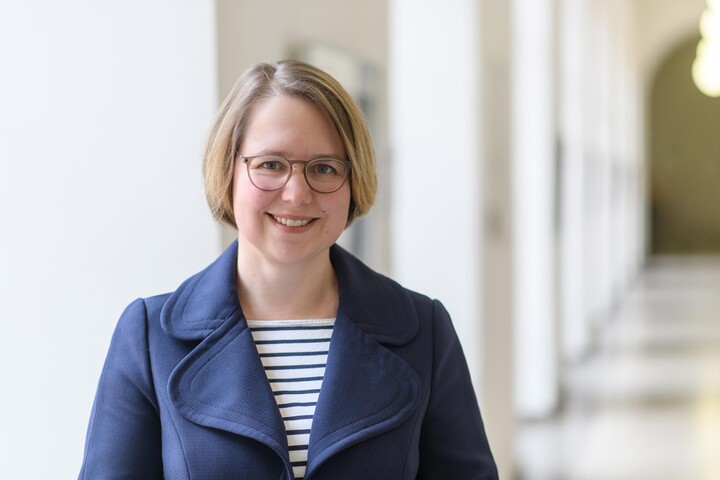 Portraitfoto von Prof. Dr. Karina Karst. Sie trägt ein blau-weiß gestreiftes Oberteil und einen blauen Blazer.
