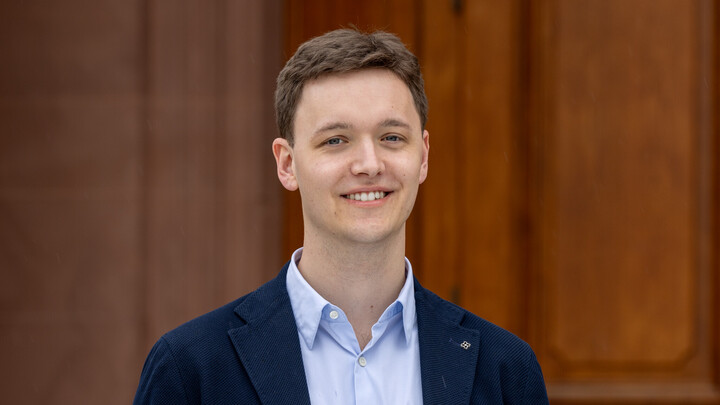 Henrik Sauer. He is wearing a white shirt and a black jacket.