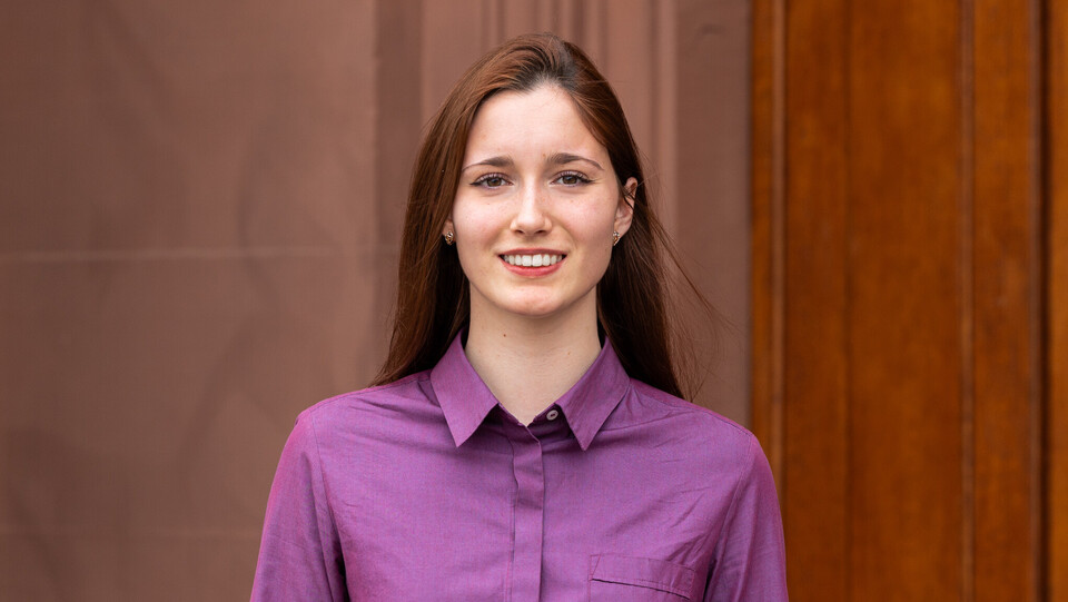 Kseniia Gorokhovska, wearing a purple shirt.