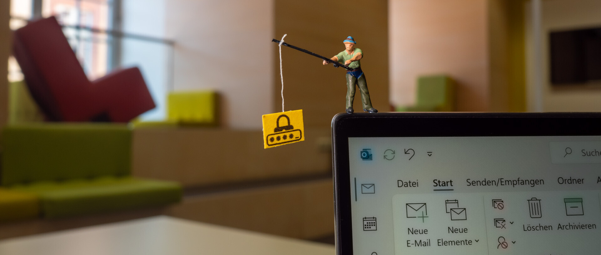 The photo shows a miniature figure standing on a screen and fishing. A mail program is open on the screen, giving the impression that the figure is fishing for mails.