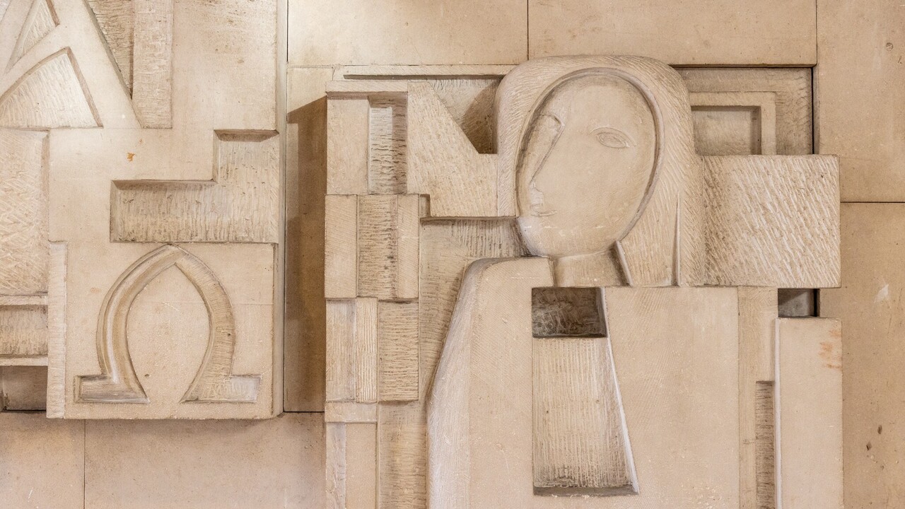 Gesicht in Steinmauer eingemeißelt